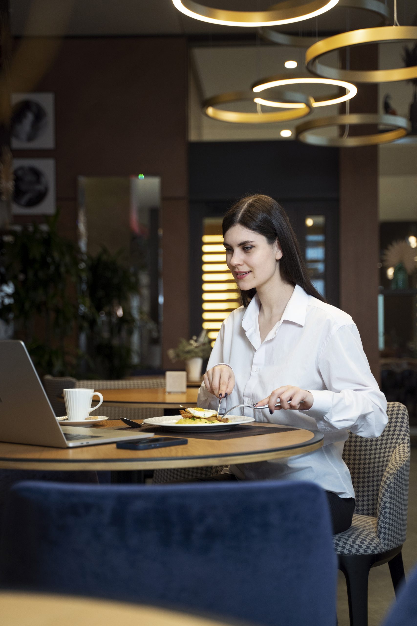 young-woman-eating-breakfast-hotel-restaurant